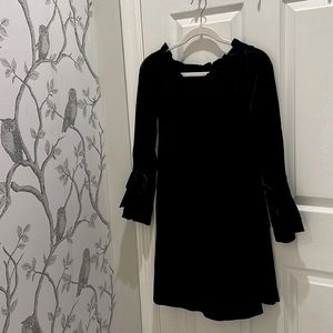 Black, lightweight dress Lined. Ribbon bows on end of sleeves.